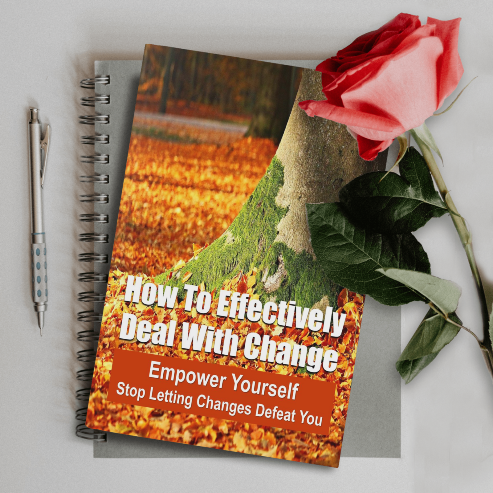 How to effectively deal with change ebook with a red rose, ballpoint pen and notebook in the background