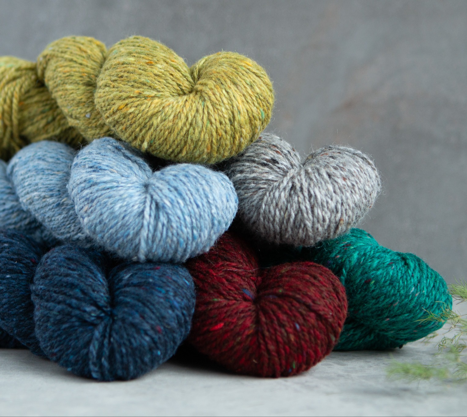 Deas yarn skeins in a pile.