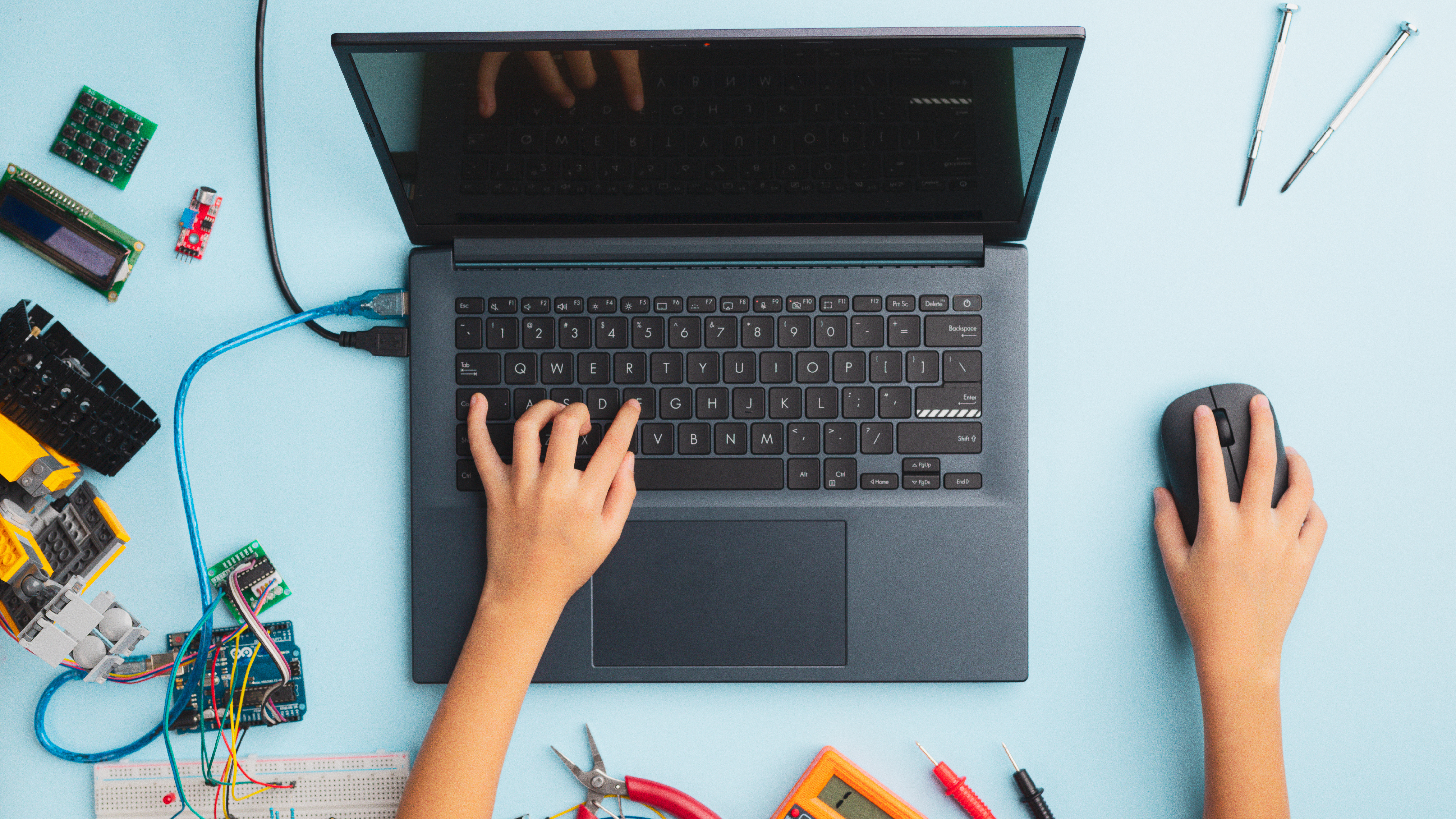 hands working on a laptop