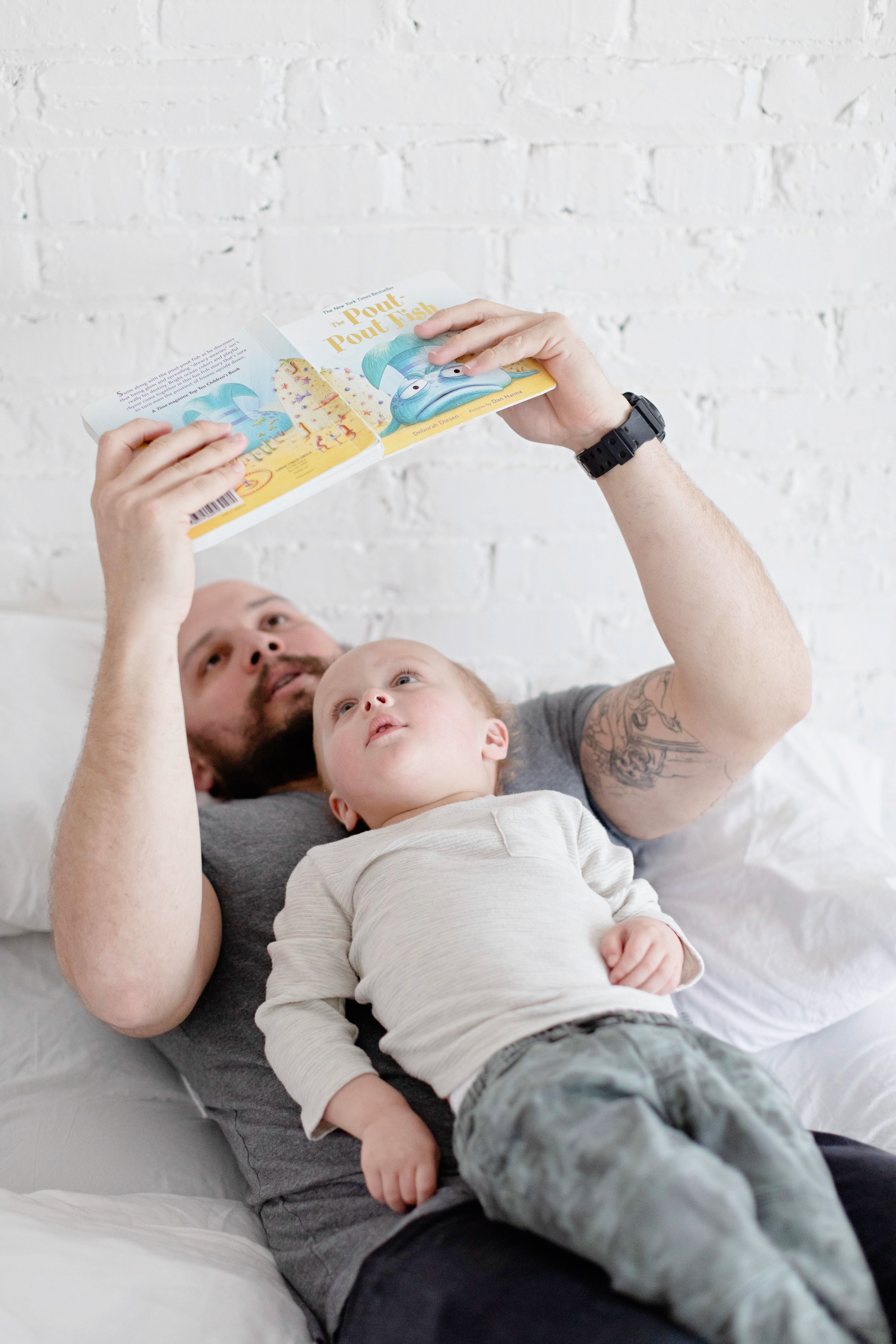 Dad reading to toddler in sleep routine before bedtime