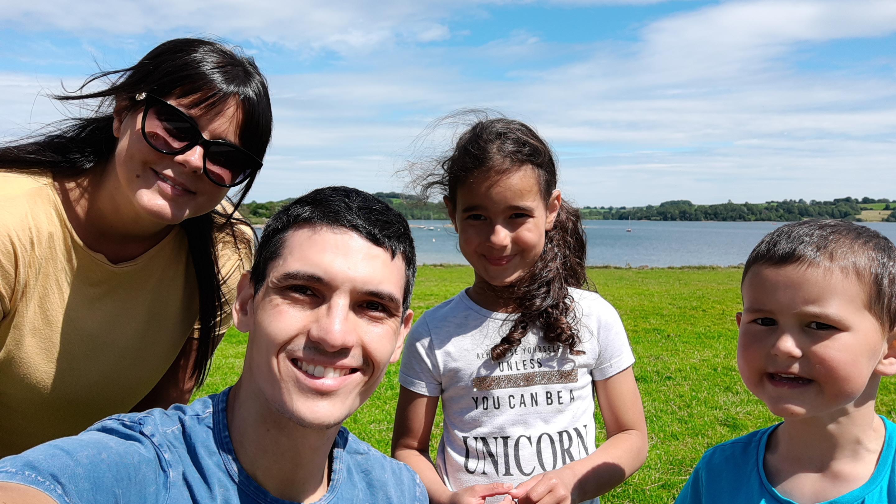 Family smiling in a park