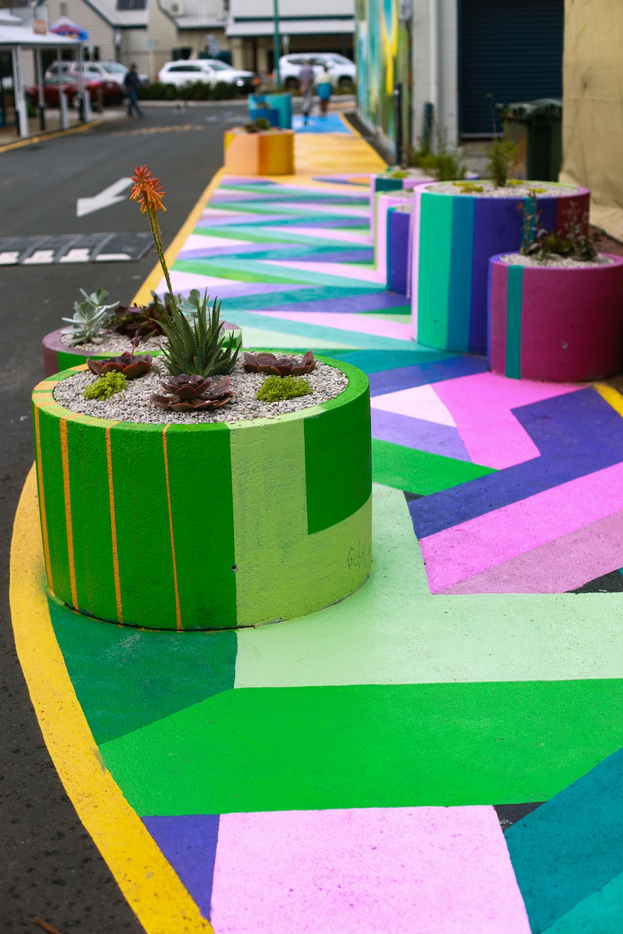 Brightly coloured asphalt and concrete planters on Hannay Lane, Dunsborough Western Australia. Photo credit RAC