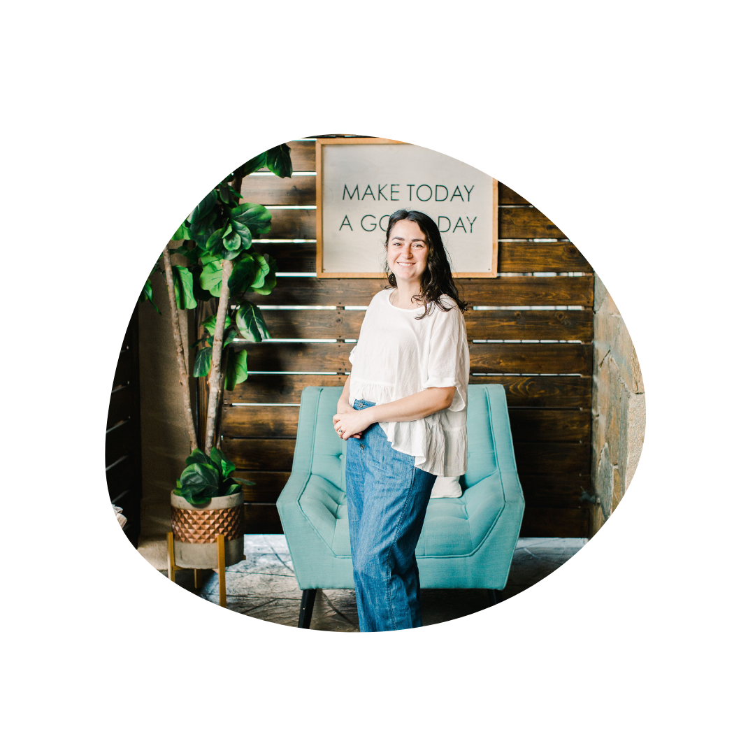 course creator Gigi, standing before a wood wall and turquoise chair