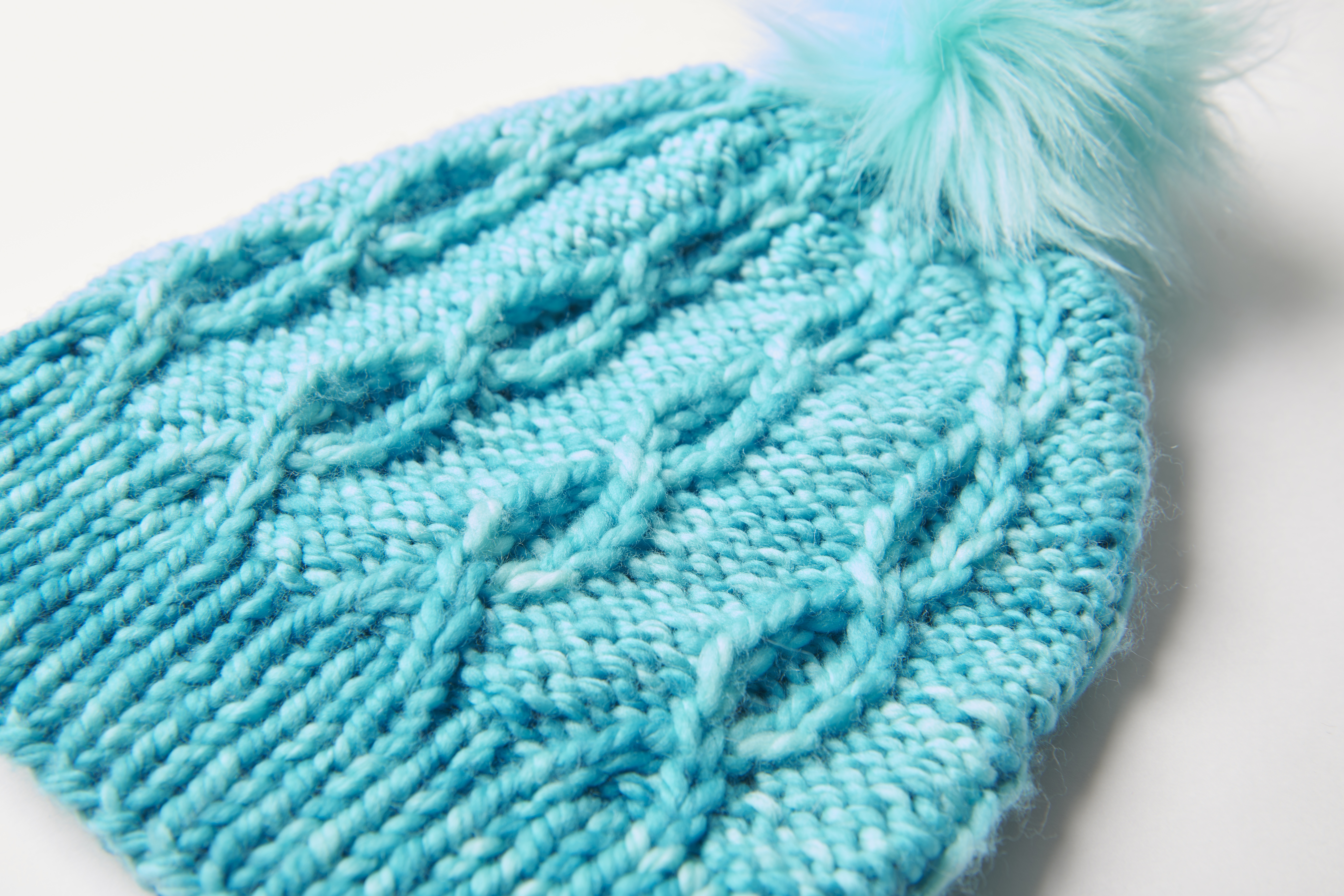 bulky cabled knit hat with pom