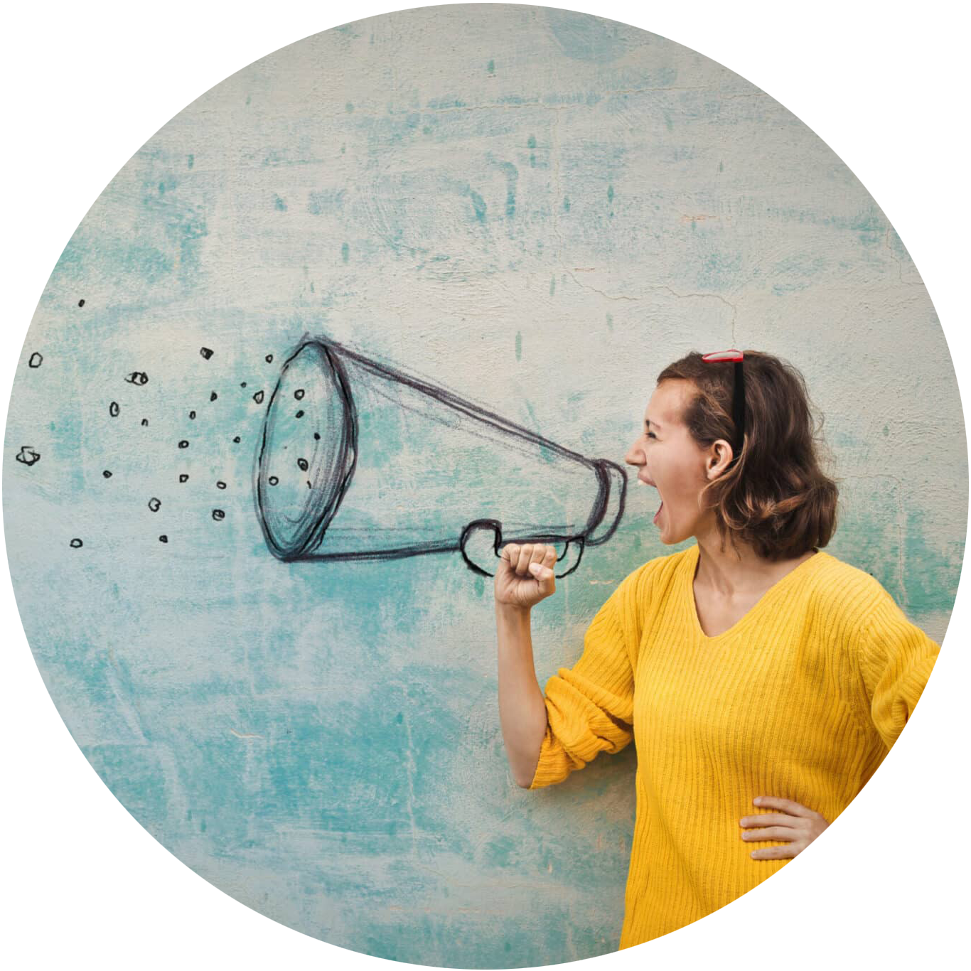 Person with their hand on their hip speaking into a bullhorn