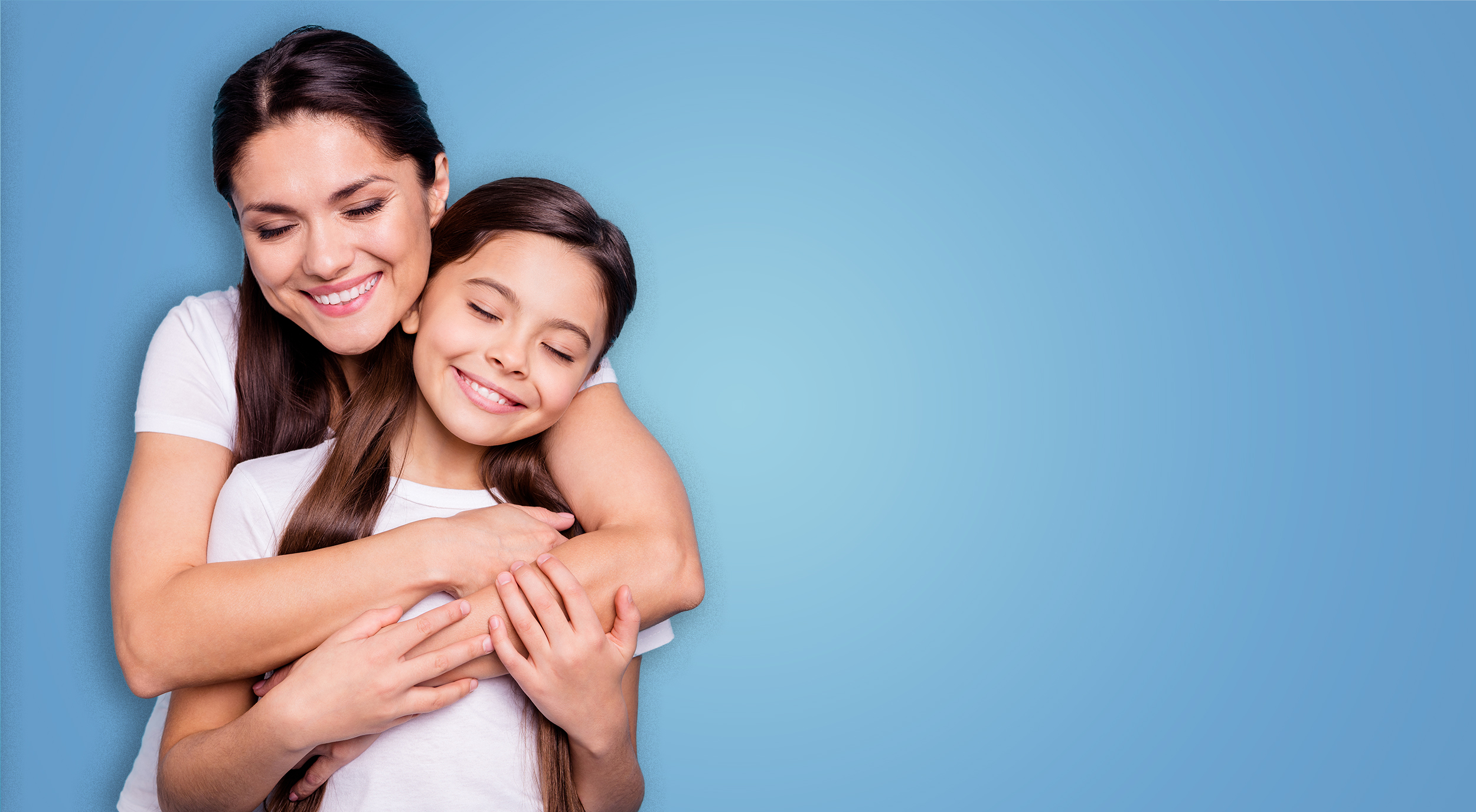 mother and daughter hugging big smiles eyes closed