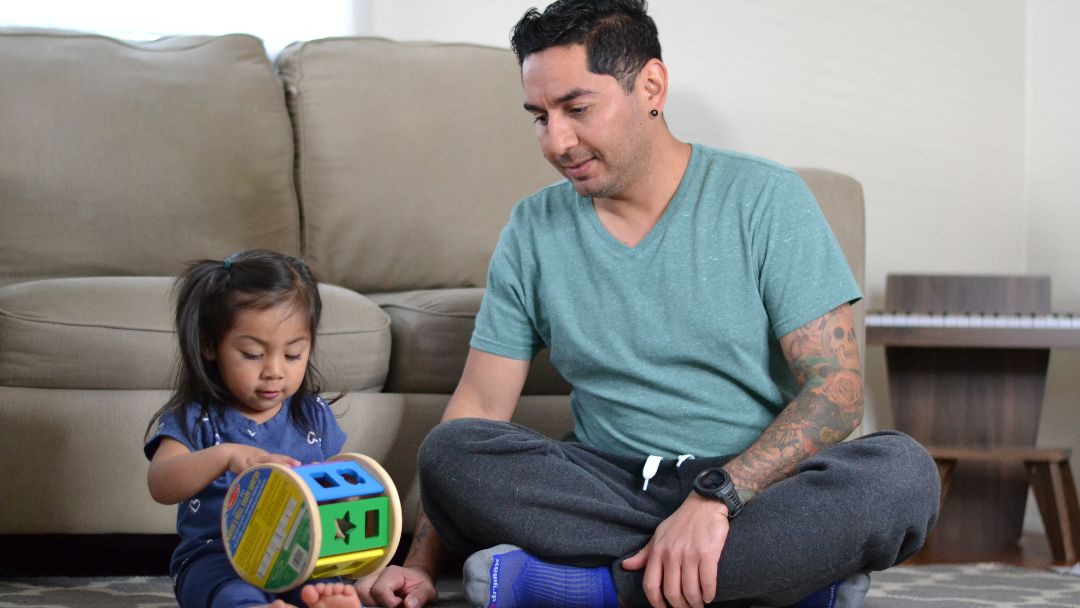 father playing with daughter