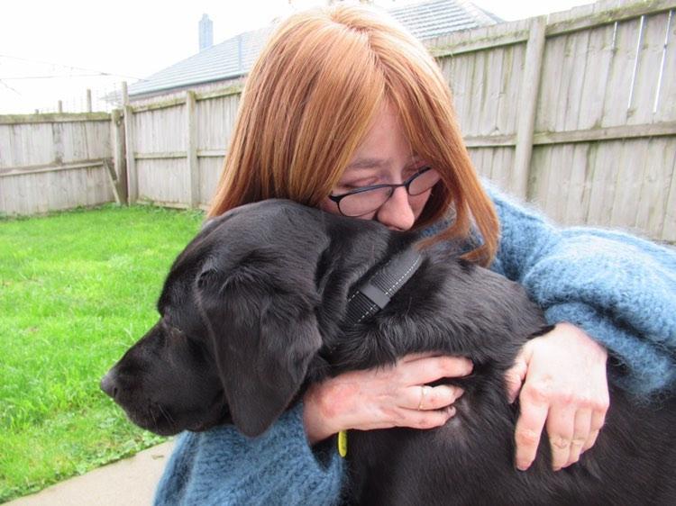 Claudia hugging her dog