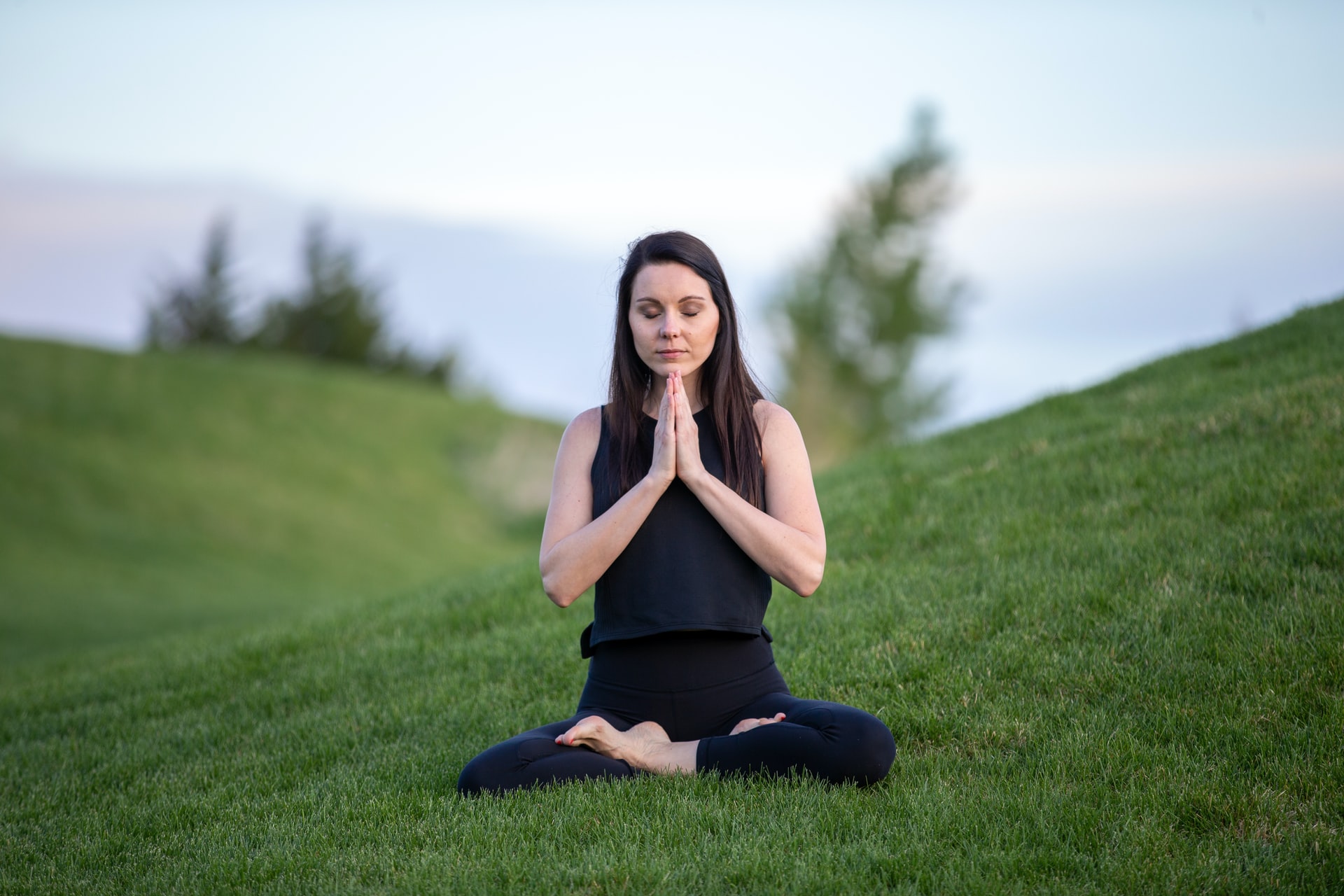 woman sitting mindfullly in nature