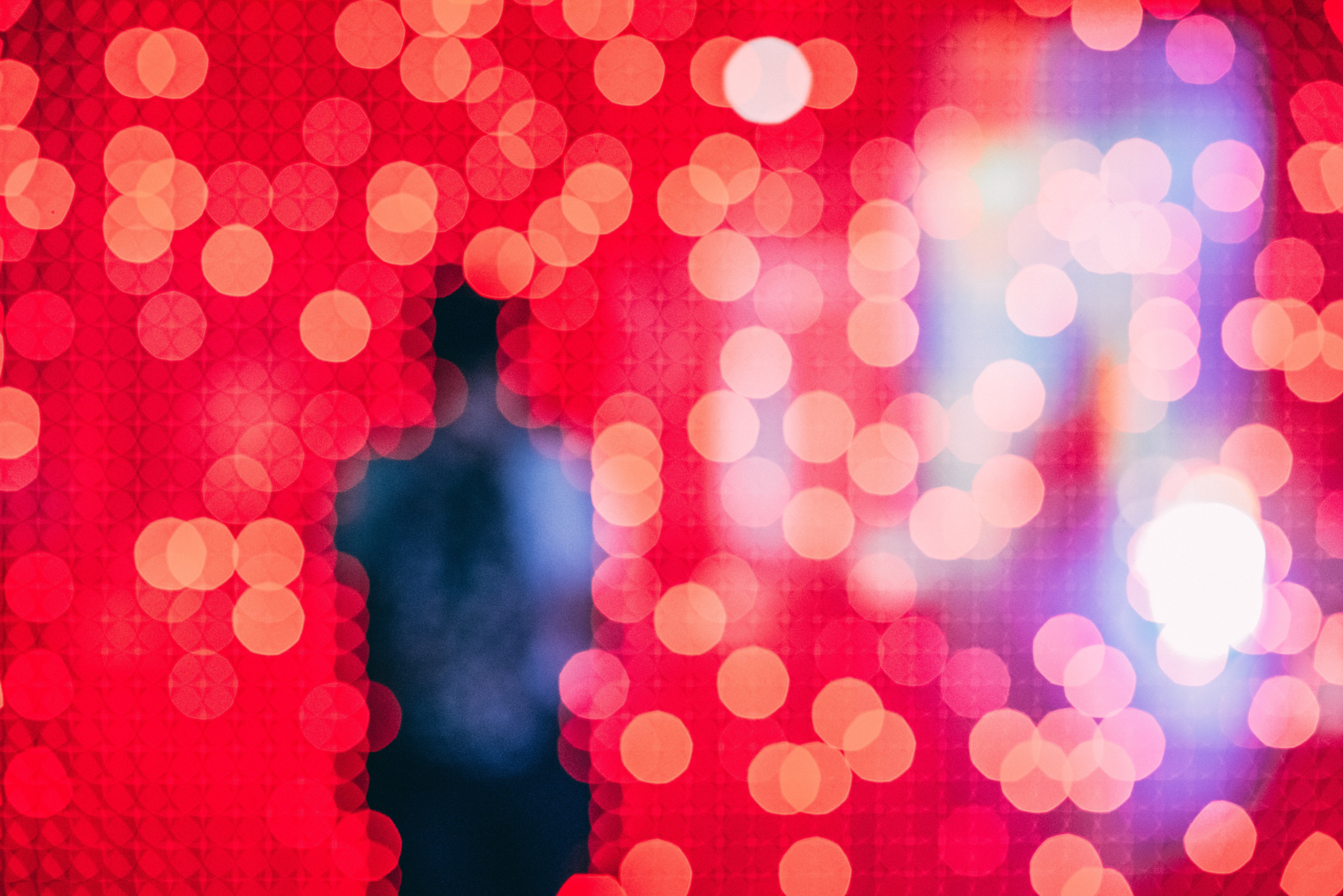 man standing in red lit room