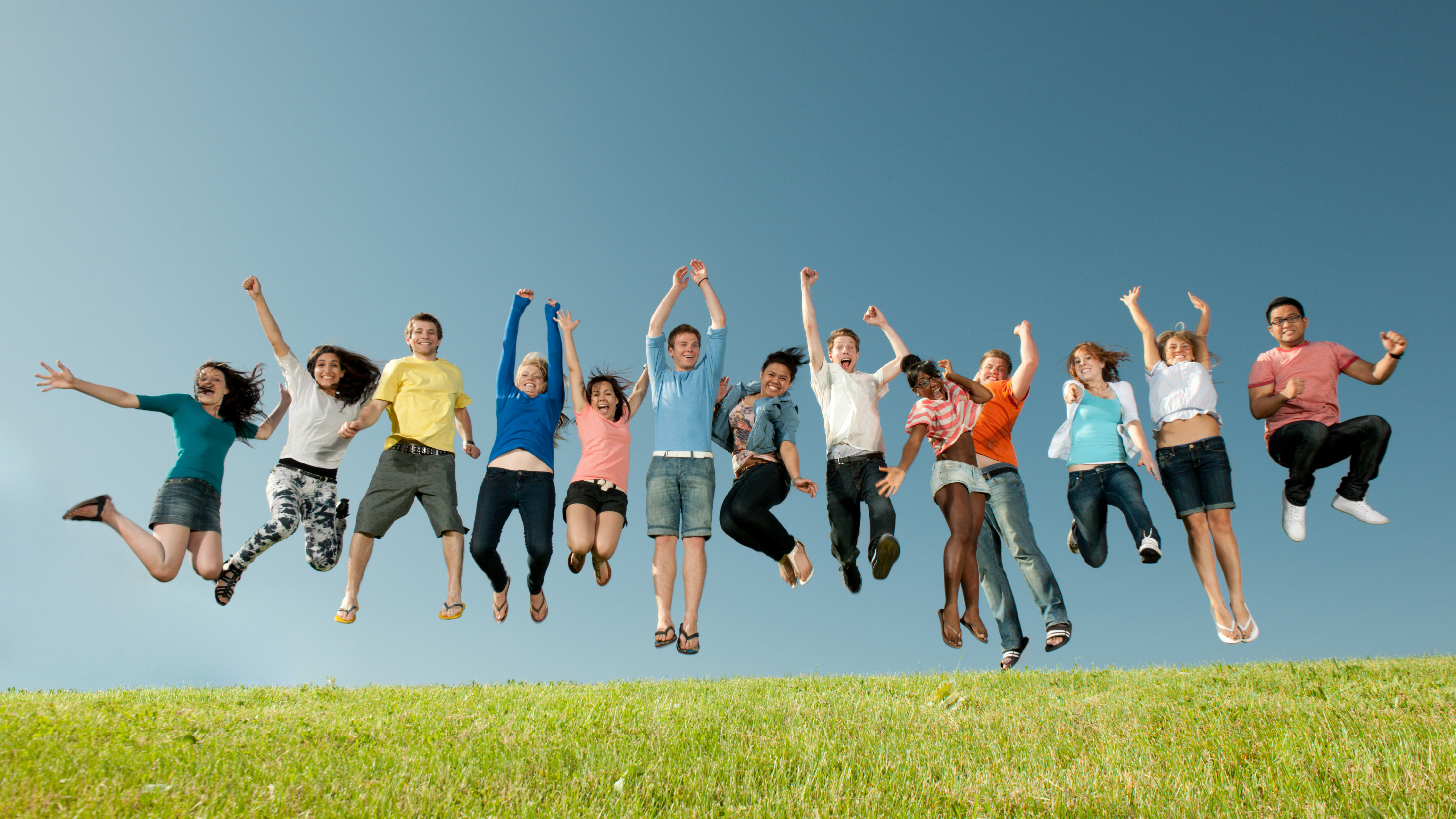 students jumping in the air in celebration