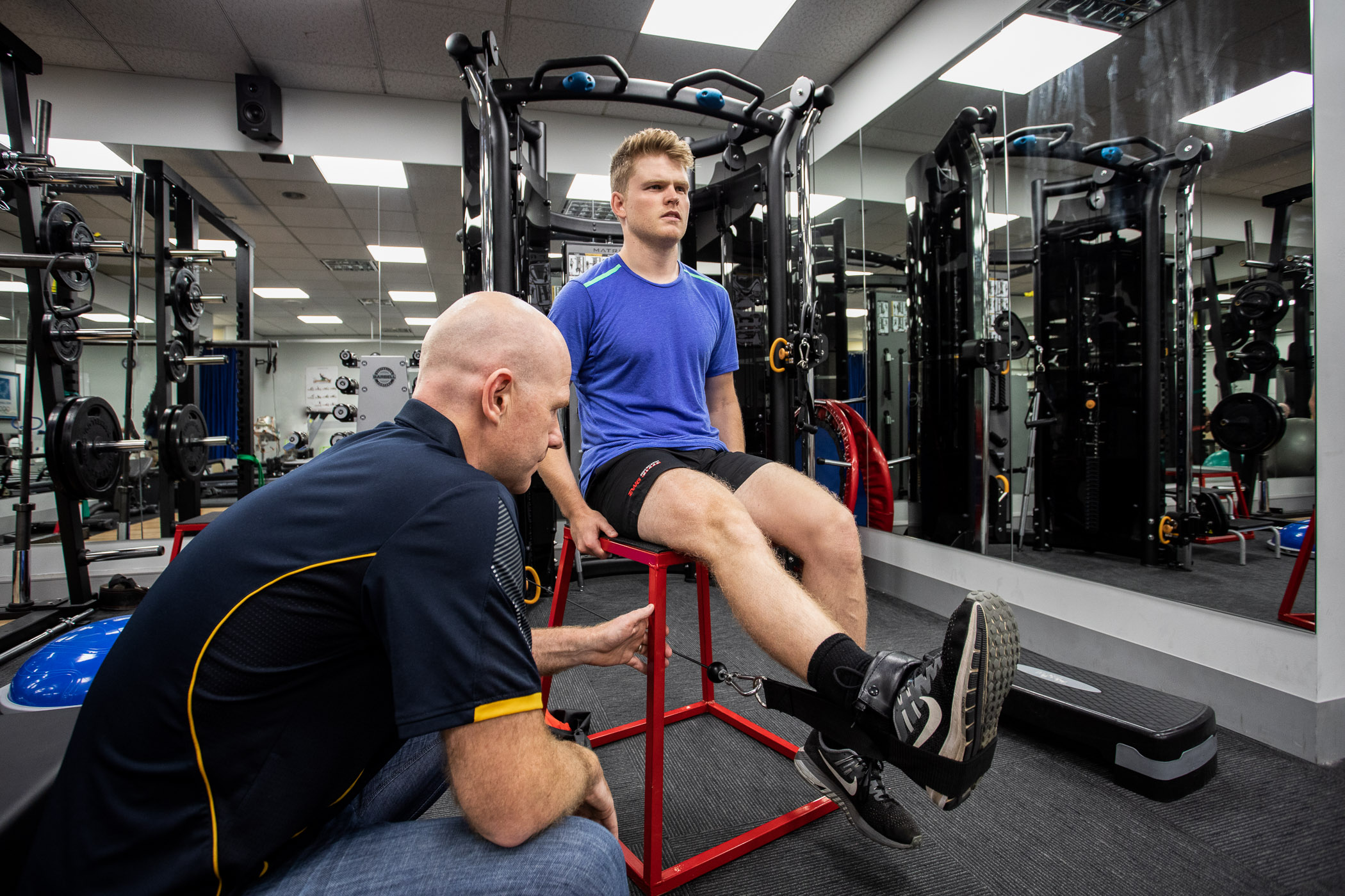 Mick Hughes supervising a client doing ACL recovery exercises.