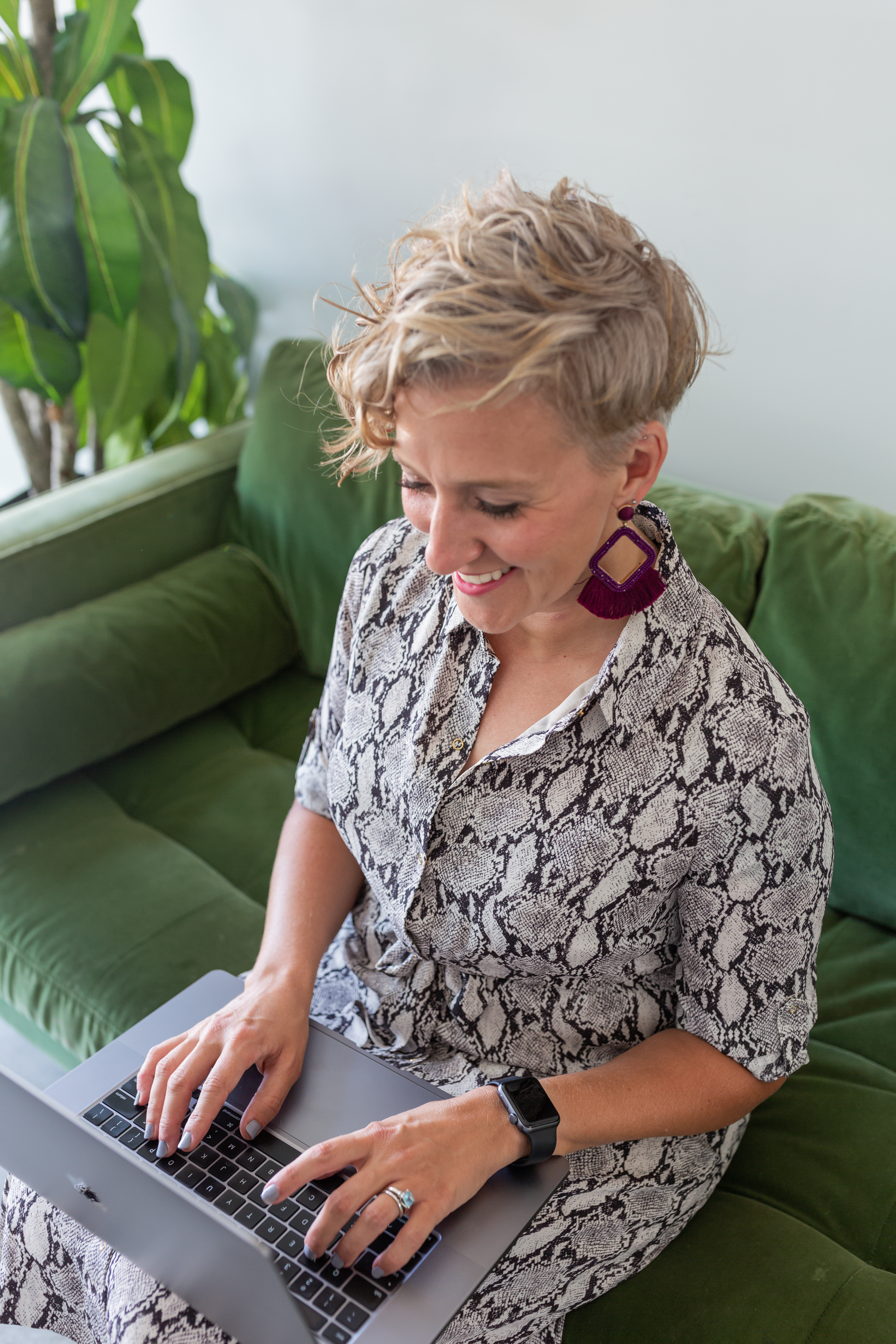 social media coach, blonde curly hair girl on green couch